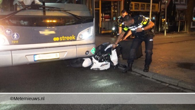 scooter onder streekbus in Groningen